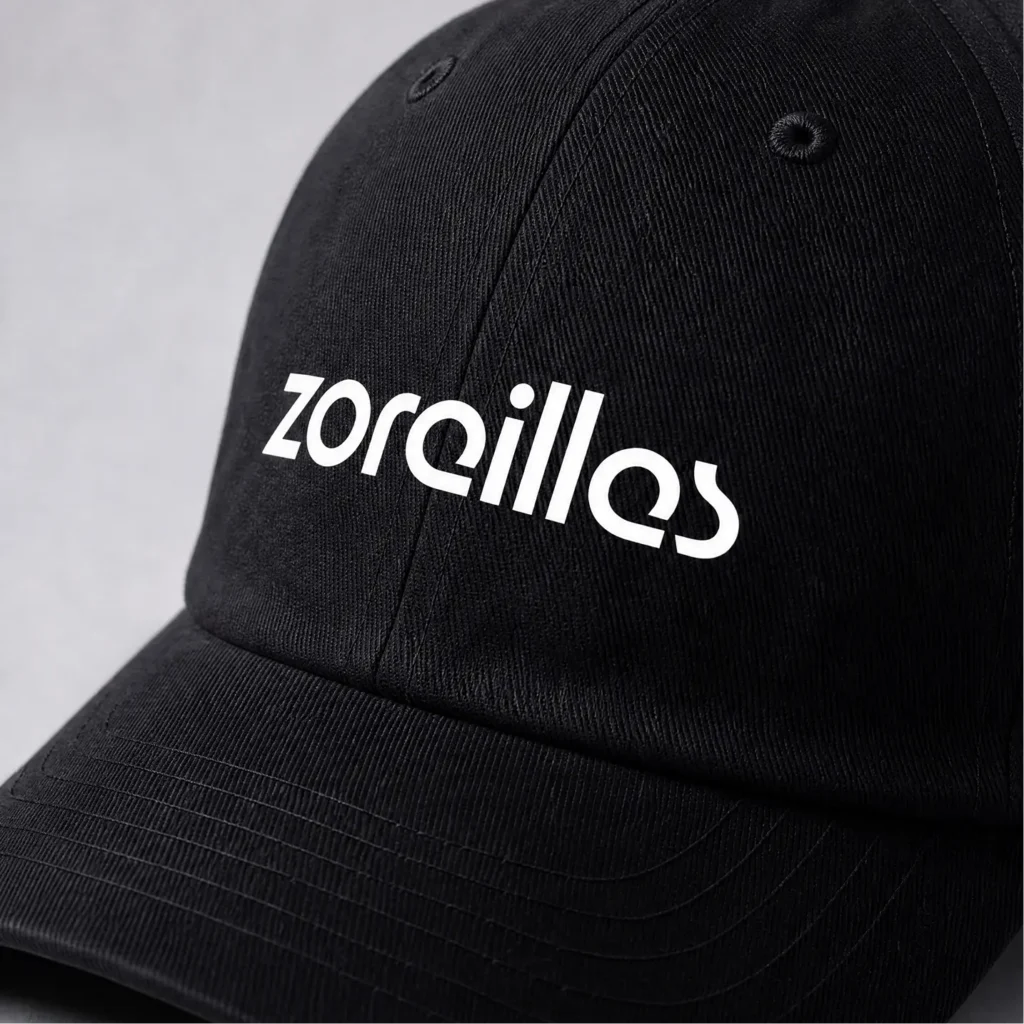 Close-up of black Zoreilles cap with white wordmark